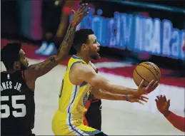  ?? CRAIG MITCHELLDY­ER — THE ASSOCIATED PRESS ?? Warriors guard Stephen Curry shoots in front of Trail Blazers forward Derrick Jones Jr., left, during the first half on Wednesday in Portland, Ore.