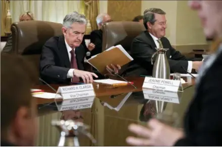  ?? JACQUELYN MARTIN — THE ASSOCIATED PRESS FILE ?? Federal Reserve Chair Jerome Powell, left, and Randal Quarles, vice chair for supervisio­n, gather their things at the end of a Federal Reserve Board meeting at the Marriner S. Eccles Federal Reserve Board Building in Washington.