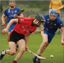  ??  ?? Adam Nolan stoops to gather the ball for Oulart-The Ballagh as Mark Boland (Tara Rocks) prepares to challenge in Camolin on Saturday.