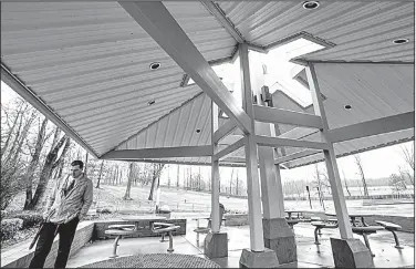  ?? Arkansas Democrat-Gazette/MITCHELL PE MASILUN ?? Scott Gauntt, superinten­dent of Westside Consolidat­ed School District, walks through the memorial garden at Westside Middle School. The five beams supporting the pavilion symbolize the five victims and form a cross at the top that can be seen from any...