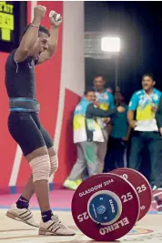  ?? — PTI ?? Sukhen Dey celebrates his gold in the 56kg men’s weightlift­ing event in Glasgow on Thursday night.