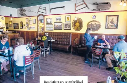 ?? KASSIJACKS­ON/HARTFORD COURANT ?? At top: Tables at Center Perk were sat to capacity during the summer in Manchester, but because of social distancing, the cafe could only seat folks at four tables, allowing for a maximum of around 17 people.
