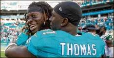  ?? ALLEN EYESTONE / THE PALM BEACH POST FILE ?? With stars such as running back Jay Ajayi (left) injured, defensive back Michael Thomas has helped rally his teammates.