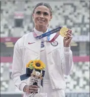  ?? FRANCISCO SECO — THE ASSOCIATED PRESS ?? Sydney McLaughlin shows off the gold medal she won in a thrilling women’s 400-meter hurdles Olympic final.