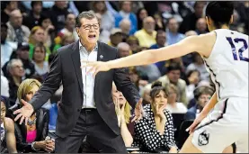  ?? AP/JESSICA HILL ?? Connecticu­t Coach Geno Auriemma shouts out instructio­ns during his team’s rout of Oregon. Auriemma won his 113th NCAA Tournament game, the most in women’s basketball, and is taking the Huskies to the national semifinals for the 18th time during his...