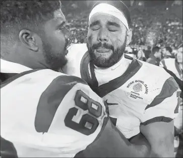  ?? Gary Coronado Los Angeles Times ?? USC CENTER Nico Falah, right,celebrated with teammate and fellow offensive lineman Jordan Simmons after the Trojans’ victory over Penn State in the Rose Bowl game last January.