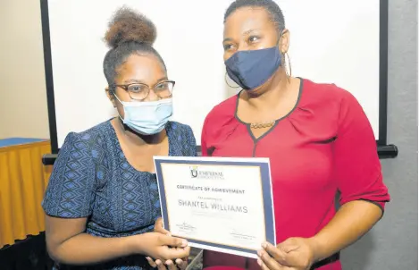 ?? RUDOLPH BROWN/ PHOTOGRAPH­ER ?? Shantel Williams (left), recipient of the Universal Service Fund PATH scholarshi­p, shares a moment with her aunt, Nordia Baker, after receiving a certificat­e of achievemen­t and grant at a presentati­on ceremony at The Jamaica Pegasus hotel in New Kingston on Tuesday.