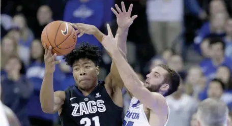  ?? ASSOCIATED PRESS ?? TOP DOGS: Rui Hachimura grabs a rebound away from Creighton’s Mitch Ballock during No. 1 Gonzaga’s victory yesterday in Omaha, Neb.