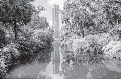 ?? PATRICK CONNOLLY/ORLANDO SENTINEL ?? A view of Bok Tower from the reflection pool at Bok Tower Gardens in Lake Wales.
