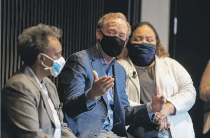  ?? PAT NABONG/SUN-TIMES PHOTOS ?? ABOVE: Microsoft President Brad Smith speaks Friday during the launch of Accelerate Chicago, a program that aims to help over 300,000 Chicagoans add digital skills. LEFT: Mayor Lori Lightfoot and Smith sign documents certifying the program.