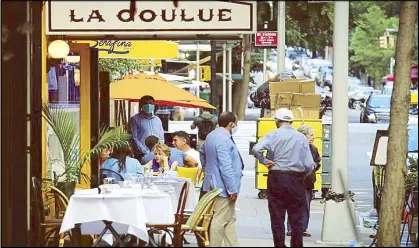  ?? AP ?? Diners eat outside La Goulue restaurant in New York on Tuesday amid the pandemic outbreak in the United States.