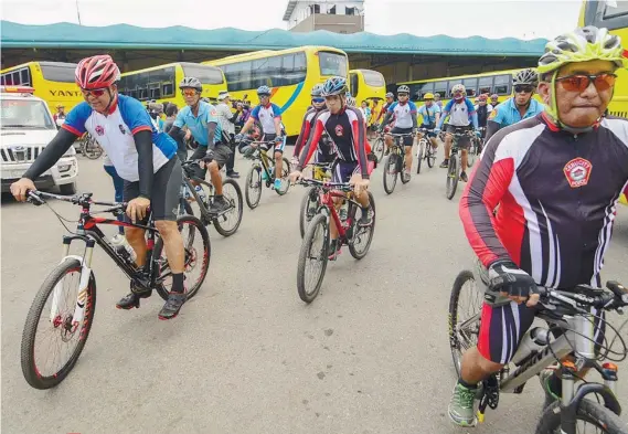  ?? SUNSTAR FOTO / ARNI ACLAO ?? BISIKLETA IGLESIA. Cops on bikes ride through the Cebu South Bus Terminal to help ensure order and safety inside the facility. They are tasked to patrol around the churches and other public converging areas in the city during the observance of the Holy...