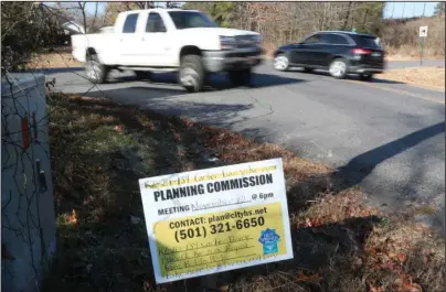  ?? The Sentinel-Record/Richard Rasmussen ?? REZONING APPLICATIO­N: Motorists turn off and on to Burchwood Bay Road at the intersecti­on with Lakeshore Drive Thursday near the old Carter family dairy. The family has applied to rezone the property for single-family housing.