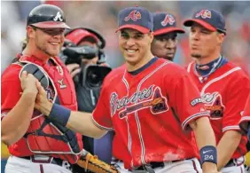  ?? AP PHOTO/JOHN BAZEMORE ?? First baseman Mark Teixeira, right, and catcher Brian McCann celebrate after the Atlanta Braves beat the New York Mets during a home game in April 2008 in Atlanta. Teixeira played college baseball at Georgia Tech but left without completing his degree when he was drafted by the Texas Rangers in 2001. He began taking classes again virtually during the pandemic and will graduate Saturday.