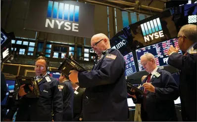  ?? Bloomberg News/MICHAEL NAGLE ?? Traders work on the floor of the New York Stock Exchange on Friday. U.S. stocks fell as investors assessed the latest news concerning possible U.S.-China tariffs.