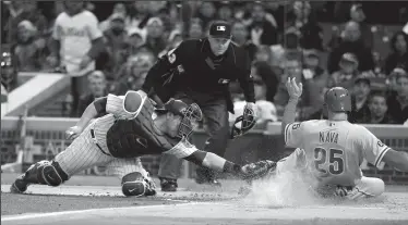  ?? NUCCIO DINUZZO/TRIBUNE NEWS SERVICE ?? The Philadelph­ia Phillies' Daniel Nava (25) scores past Chicago Cubs catcher Miguel Montero on a single by Maikel Franco in Chicago on Wednesday.