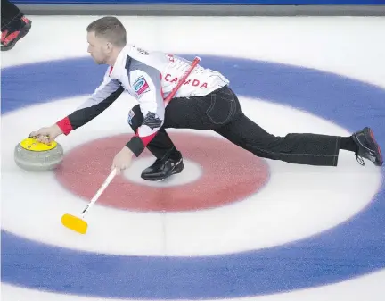  ?? JONATHAN HAYWARD /THE CANADIAN PRESS ?? Team Canada skip Brad Gushue makes a shot for a draw against Russia at the world men’s curling championsh­ip in Edmonton on Sunday morning. Gushue’s rink, which features Tom Sallows as fifth, stayed unbeaten at 2-0 with the 11-3 blowout win.