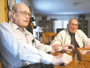  ?? STAFF PHOTO BY TIM BARBER ?? Russell Pickett, left, and James R. Yarbrough, both age 93, meet for the first time after serving on D-Day, at Omaha Beach during World War II.