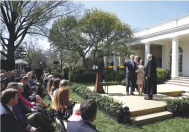  ?? ASSOCIATED PRESS PHOTOS ?? President Donald Trump watches as Supreme Court Justice Anthony Kennedy administer­s the judicial oath to Judge Neil Gorsuch in the Rose Garden of the White House.