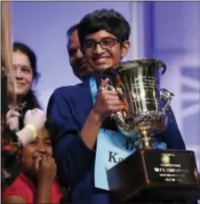  ?? CAROLYN KASTER - THE ASSOCIATED PRESS ?? Karthik Nemmani, 14, from McKinney, Texas, holds the Scripps National Spelling Bee Championsh­ip Trophy after winning the Scripps National Spelling Bee in Oxon Hill, Md., Thursday.