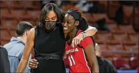  ?? TODD VAN EMST/ SEC ?? Georgia coach Joni Taylor hugs Maya Caldwell during the SEC women’s tournament. The Bulldogs took the entire week off after losing to South Carolina.