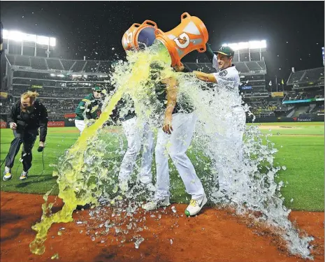  ?? THEARON W. HENDERSON / GETTY IMAGES / AFP ?? Teammates shower Oakland A’s pitcher Sean Manaea after he threw a no-hitter against the Boston Red Sox at Oakland Coliseum last Saturday. The 26-year-old southpaw struck out 10 Boston batters and threw just 108 pitches in the 3-0 victory, marking the...