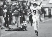  ?? ASSOCIATED PRESS ?? MICHIGAN WIDE RECEIVER Donovan Peoples-Jones (9) runs for a 79-yard touchdown run during the second half of Saturday’s game against Michigan State in East Lansing, Mich. NO. 25 WASHINGTON STATE 34, NO. 12 OREGON 20