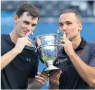  ??  ?? At the double: Jamie Murray (left) and Bruno Soares hold the Queen’s trophy