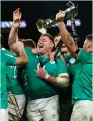  ?? (Clodagh Kilcoyne/Reuters) ?? IRELAND PLAYERS celebrate with the trophy after winning the Six Nations Championsh­ip with a 17-13 victory over Scotland on Saturday.