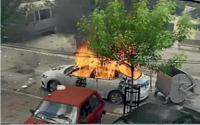  ?? AP ?? A car burns as KFOR soldiers clash with Kosovo Serbs in the town of Zvecan, northern Kosovo.