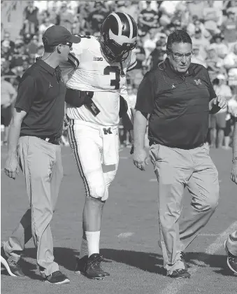  ?? MICHAEL CONROY/THE ASSOCIATED PRESS ?? Michigan quarterbac­k Wilton Speight is helped off the field after being injured during a game against Purdue at Ross-Ade Stadium on Saturday in West Lafayette, Ind.