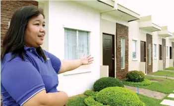  ?? SUNSTAR FILE ?? ADDRESSING THE BACKLOG. A manager of a real estate firm shows model units of her company’s socialized housing developmen­t in Carcar City.