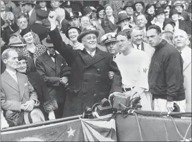  ?? ASSOCIATED PRESS ?? In this Oct. 5, 1933, file photo, President Franklin D. Roosevelt prepares to throw out the ceremonial first pitch at at Griffith Stadium in Washington, before Game 3 of baseball’s World Series as Washington Senators manager Joe Cronin, third from right, and New York Giants manager Bill Terry, second from right, look on. The President uncorked an almost wild throw that sent the players scrambling.