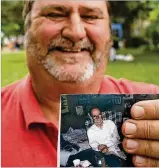  ?? TY GREENLEES / STAFF ?? Mike Kessler shows a photo of his late friend Tommy McIntosh, whose ashes he is spreading at horse racing tracks throughout the U.S., as McIntosh was a lifelong horse racing fan.