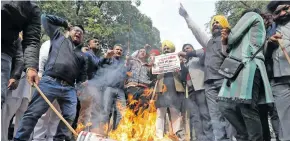  ??  ?? People burn placards and effigies of India’s main opposition Congress party leaders, Sajjan Kumar and Kamal Nath, during a protest in New Delhi.