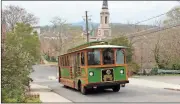  ?? Photos by Diane Wagner, Rome News-Tribune ?? BELOW: The Toonervill­e Trolley chugs up East Fifth Avenue to the Clock Tower. The exchange students will cap their visit Thursday with a farewell dinner at the Rome-Floyd ECO Center.