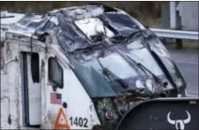  ?? ELAINE THOMPSON — THE ASSOCIATED PRESS ?? The engine from an Amtrak train crash onto Interstate 5 on Monday sits on a transport carrier before being driven away from the scene, Wednesday in DuPont, Wash. Federal investigat­ors in the deadly train wreck want to know whether the engineer was...