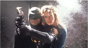  ?? WARNER BROS. ?? The Caped Crusader (Michael Keaton) saves Vicki Vale (Kim Basinger) from certain doom in “Batman.”