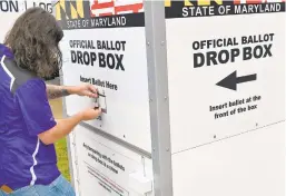  ?? JEFFREY F. BILL/CAPITAL GAZETTE ?? Dan Oltman, precinct and polling place manager, places a lock on the Official Ballot Drop Box at the Michael E. Busch Annapolis Library in Ward 2.