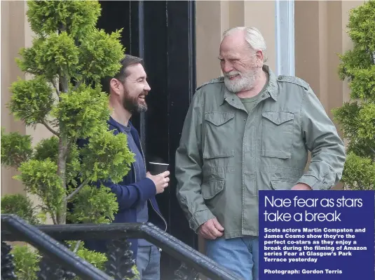  ?? ?? Scots actors Martin Compston and James Cosmo show they’re the perfect co-stars as they enjoy a break during the filming of Amazon series Fear at Glasgow’s Park Terrace yesterday
Photograph: Gordon Terris