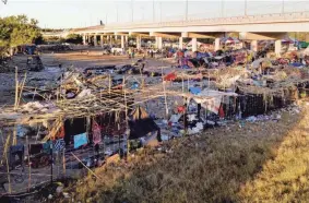  ?? JULIO CORTEZ/AP ?? Migrants, many from Haiti, are seen in an encampment near the Del Rio Internatio­nal Bridge in Del Rio, Texas, Friday.