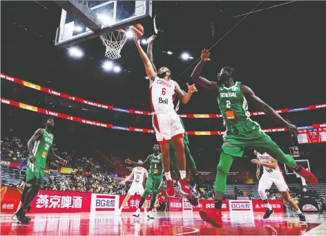  ?? ZHIZHAO Wu/GETTY IMAGES ?? Canadian guard Cory Joseph drives to the basket on Thursday during an 82-60 first-round victory over Senegal at Dongguan Basketball Center in Dongguan, China. It was Canada’s first win at the FIBA World Cup since a 2002 victory over Venezuela in Indianapol­is.