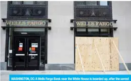  ??  ?? WASHINGTON, DC: A Wells Fargo Bank near the White House is boarded up, after the unrest in downtown Washington, DC, in this file photo