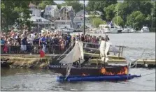  ?? GASPEE DAYS COMMITTEE VIA AP ?? Spectators watch an annual ceremonial burning of a replica of the ship HMS Gaspee in Warwick, R.I. The British customs schooner Gaspee had been sent in March 1772 to enforce maritime trade laws and prevent smuggling around Newport, R.I. In June 1772, a...