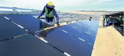  ??  ?? BIG: 611 000 solar panels are being installed in long rows on galvanised steel structures at the new Paleisheuw­el Solar Park in the Sandveld Region.