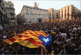  ?? DAVID RAMOS, GETTY IMAGES ?? Catalans gather outside the parliament in Barcelona on Friday to celebrate the vote for independen­ce from Spain.