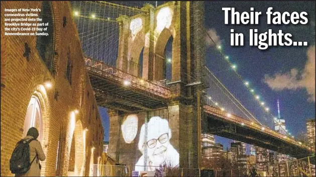 ??  ?? Images of New York’s coronaviru­s victims are projected onto the Brooklyn Bridge as part of the city’s Covid-19 Day of Remembranc­e on Sunday.