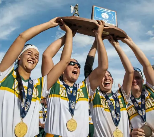  ?? Caitlin Lee/Post-Gazette ?? Penn-Trafford’s seniors lift their hardware after beating Lampeter-Strasburg for the PIAA Class 5A softball title Friday in University Park.