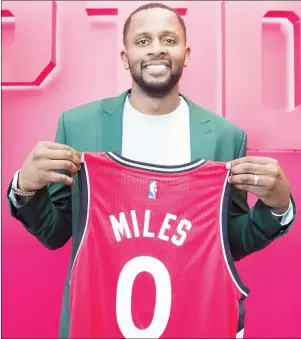  ?? $1 1)050 ?? Newly-acquired Toronto Raptors player C.J. Miles poses with his jersey in Toronto on Tuesday.
