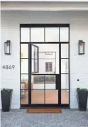  ??  ?? Arcadia area house features a custombuil­t steel Dutch entryway door.